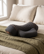 ArchRest neck pillow on an olive linen throw